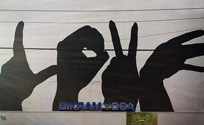 Street mural of four silhouetted hands spelling the word 'LOVE' in the Hampden neighborhood in Baltimore