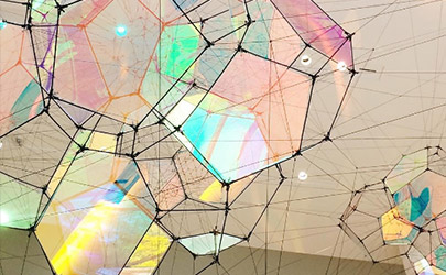 An art installation of geometric glass structures refract various colors of light at the Baltimore Museum of Art